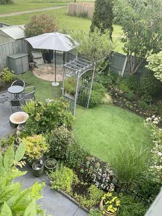 an aerial view of a garden with lawn and patio furniture in the back yard area