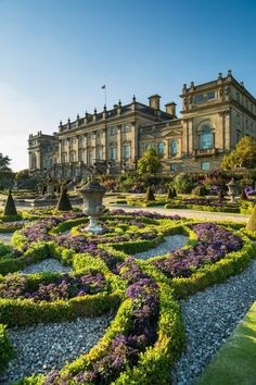 a large building with lots of plants in front of it