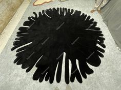 a large black rug on top of a white floor