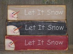 three wooden signs with snowmen painted on them, one says let it snow and the other says let it snow