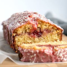 a loaf of strawberry bread on top of a cutting board with one slice cut off