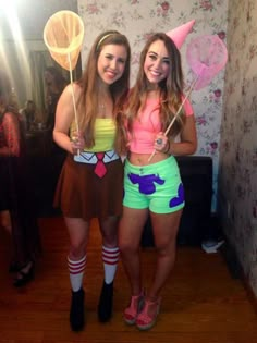 two girls dressed up in costumes for halloween