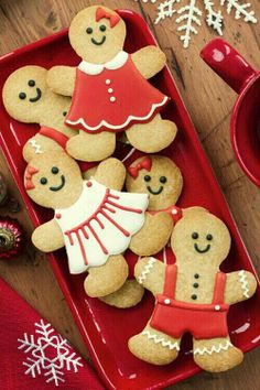 gingerbread cookies decorated with icing on a red tray