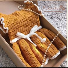 an open box with some knitted items in it