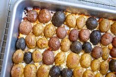 a metal pan filled with different types of baked goods on top of a countertop