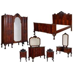 an assortment of antique furniture including a bed, dresser and mirror