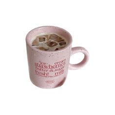 a pink coffee mug filled with ice and some type of food on top of it