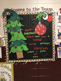 a bulletin board with christmas trees and other items on the wall in front of it