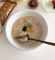 a bowl of oatmeal with an egg on top and other breakfast foods