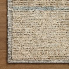 a close up of a rug on a wooden floor with a wood flooring surface