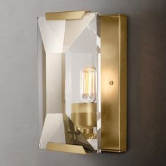 a light that is on the wall next to a glass block with a bulb in it