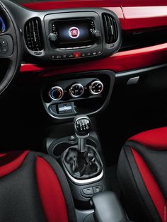 the interior of a red and black car