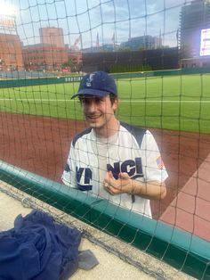 a man standing in front of a baseball field