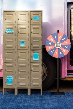 a set of lockers with water drops painted on them and a numbered spinvwheel next them Pop Up Theatre, Colorful Pop Up Store, Louis Vuitton Pop Up, Blue Pop Up Store, Hydration Station