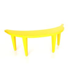 a yellow bench sitting on top of a white floor