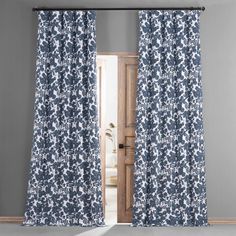 an open door with blue and white curtains