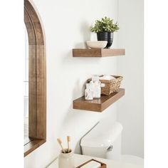 two wooden shelves above a toilet in a bathroom