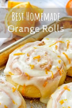 orange rolls with white icing and orange zest on top in a baking pan