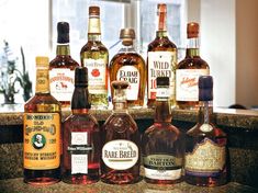 several bottles of alcohol lined up on a counter