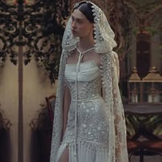 a woman in a white wedding dress and veil