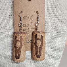 pair of cork earrings with hand painted shoes on them