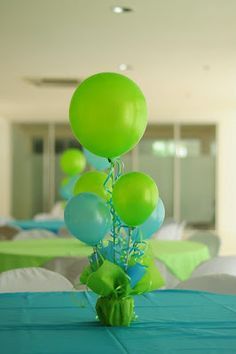 green and blue balloons are on the table