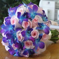 a bouquet of flowers sitting on top of a wooden table