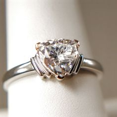 a ring with a heart shaped diamond on it