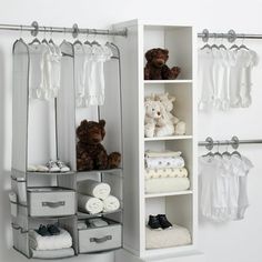 an organized closet with baby clothes and teddy bears