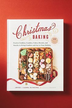 the book christmas baking is sitting on a red surface