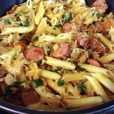 a bowl filled with pasta and meat covered in sauce