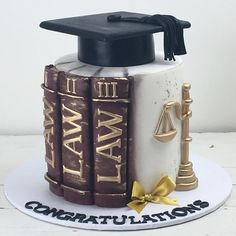 a graduation cake made to look like law books