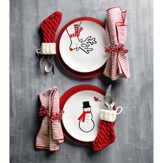 two red and white plates with snowmen on them, one has a bow tie around the edge