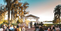 a wedding ceremony in front of an outdoor gazebo