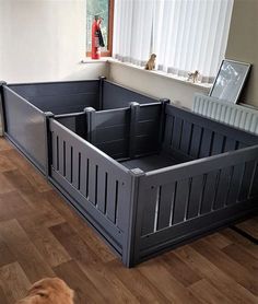 a dog laying on the floor in front of a large wooden crate that has been built into it