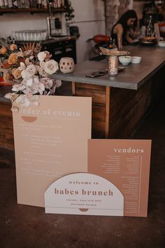 a table with menus and flowers on it next to a sign that reads vendor of events