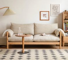 a living room scene with focus on the couch and coffee table in the foreground