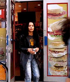 a woman is standing in the doorway of a fast food restaurant