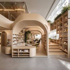 the interior of a modern library with bookshelves and plants on shelves in it