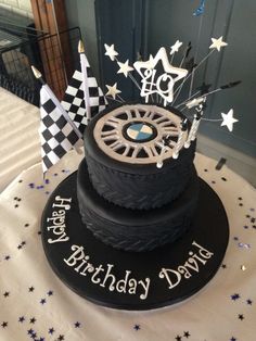 a black and white birthday cake sitting on top of a table