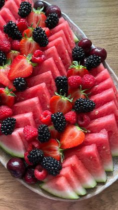 watermelon slices and berries arranged on a platter