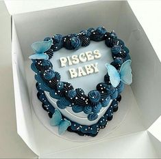 a blue heart shaped cake with the words pisces baby written on it