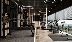 a gym with treadmills, exercise machines and windows overlooking the cityscape