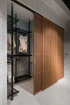 an open closet with wooden slats on the doors