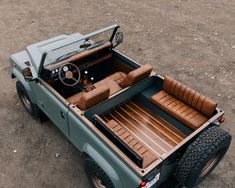 an old green jeep with leather seats in the back