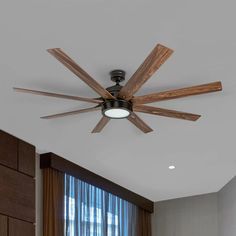 a ceiling fan with wooden blades in a living room