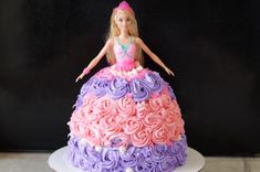 a barbie doll cake with pink, purple and lavender frosting on the bottom tier