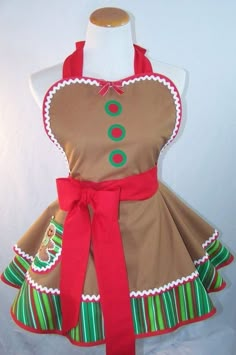 a dress made to look like a gingerbread christmas tree with green and red trim