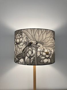 a lamp that is on top of a wooden stand with a dragonfly sitting on it