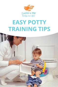 a woman sitting on the floor next to a baby in a potty reading a book